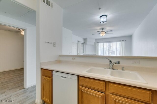 7163 S Durango Dr Unit 302, Las Vegas, NV 89113 - kitchen with dishwasher, a ceiling fan, brown cabinets, light wood-style floors, and light countertops
