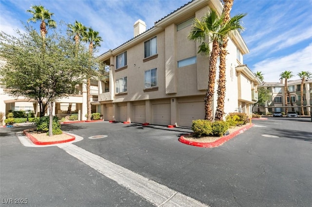 7163 S Durango Dr Unit 302, Las Vegas, NV 89113 - view of property with a residential view and a garage
