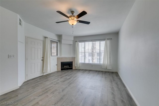 7163 S Durango Dr Unit 302, Las Vegas, NV 89113 - unfurnished living room featuring wood finished floors, a ceiling fan, and a fireplace