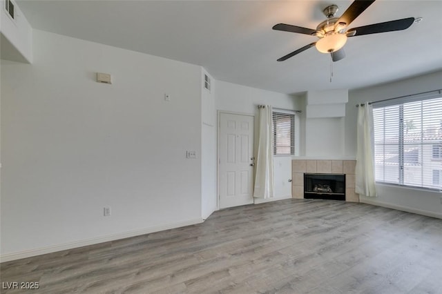 7163 S Durango Dr Unit 302, Las Vegas, NV 89113 - unfurnished living room with wood finished floors, a ceiling fan, and a fireplace