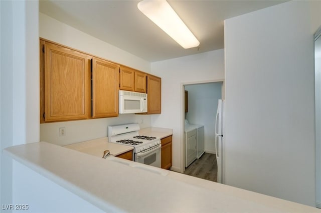 7163 S Durango Dr Unit 302, Las Vegas, NV 89113 - kitchen with white appliances, independent washer and dryer, light countertops, brown cabinets, and wood finished floors