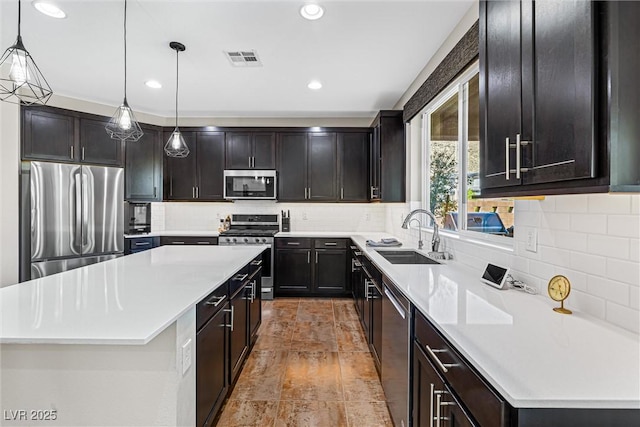 7017 Pearl Hilltop Ct, Las Vegas, NV 89148 - kitchen featuring stainless steel appliances, a center island, decorative backsplash, and recessed lighting