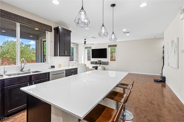7017 Pearl Hilltop Ct, Las Vegas, NV 89148 - kitchen featuring open floor plan, dishwasher, light countertops, a kitchen island, and recessed lighting
