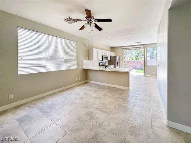 3532 Mountain Park St, Las Vegas, NV 89129 - kitchen with appliances with stainless steel finishes, a peninsula, a ceiling fan, light countertops, and white cabinetry