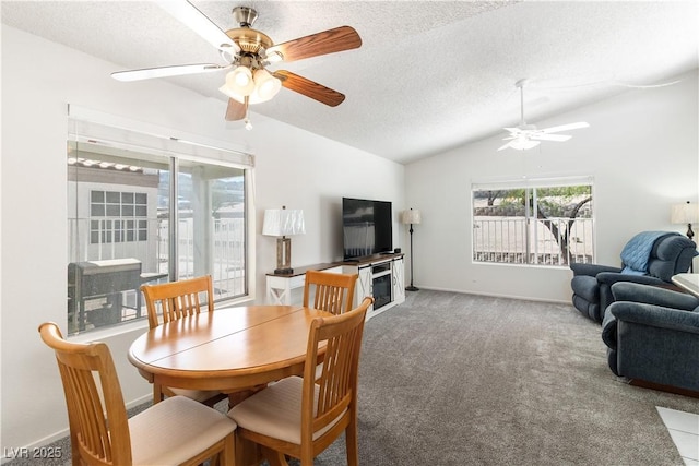 2152 High Dunes Ln, Laughlin, NV 89029 - carpeted dining area with ceiling fan, lofted ceiling, a textured ceiling, and a glass covered fireplace