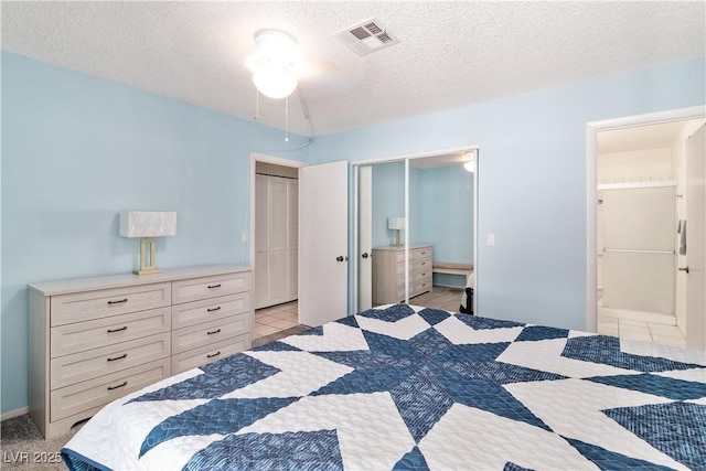 2152 High Dunes Ln, Laughlin, NV 89029 - bedroom featuring a textured ceiling, ensuite bath, and light tile patterned flooring