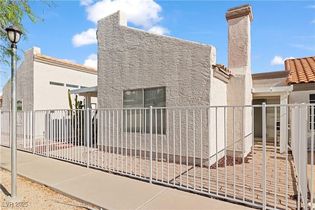 2152 High Dunes Ln, Laughlin, NV 89029 - view of side of home with stucco siding and a tiled roof