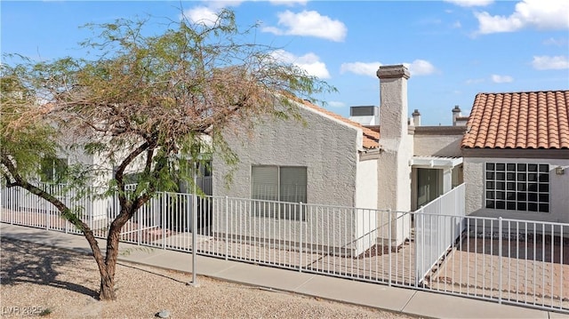2152 High Dunes Ln, Laughlin, NV 89029 - back of property featuring stucco siding, a tiled roof, and a chimney
