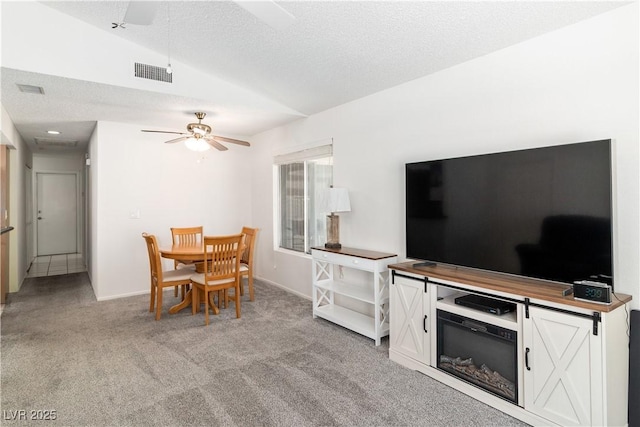 2152 High Dunes Ln, Laughlin, NV 89029 - living area featuring ceiling fan, light colored carpet, vaulted ceiling, and a textured ceiling