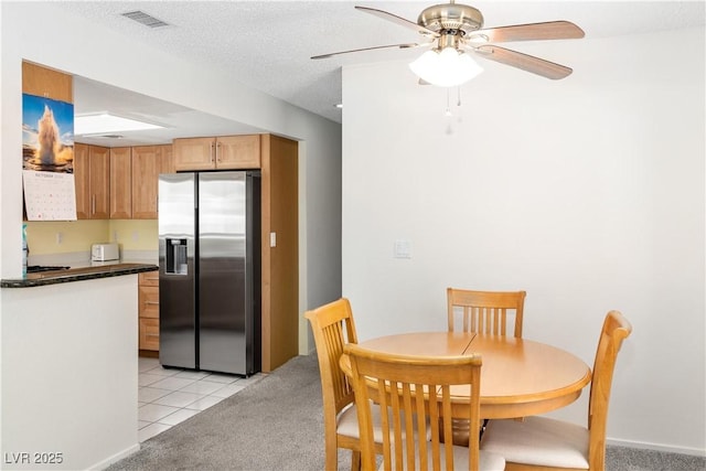 2152 High Dunes Ln, Laughlin, NV 89029 - dining area with ceiling fan, light tile patterned floors, and light colored carpet