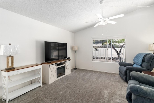 2152 High Dunes Ln, Laughlin, NV 89029 - living area with lofted ceiling, carpet, a ceiling fan, a textured ceiling, and a glass covered fireplace