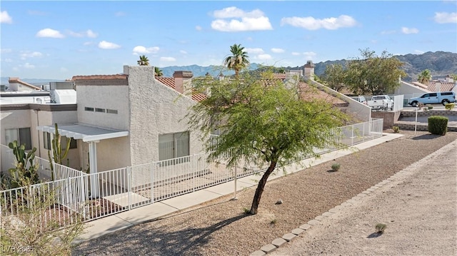 2152 High Dunes Ln, Laughlin, NV 89029 - view of side of home with stucco siding, a mountain view, and a chimney