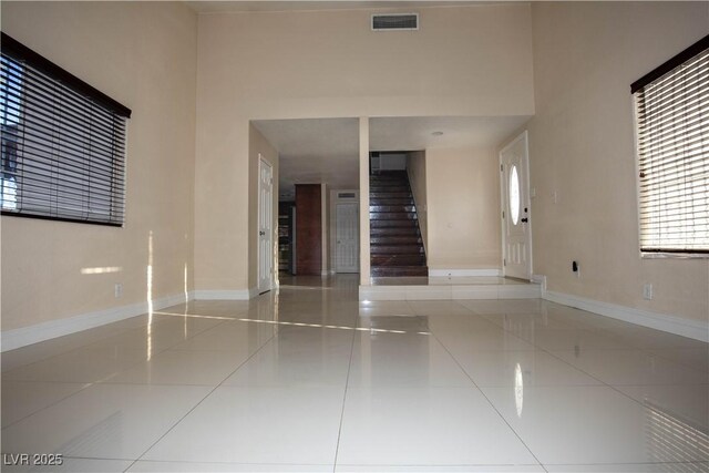 1340 Lucky St, Las Vegas, NV 89104 - spare room with tile patterned floors, stairway, and a high ceiling