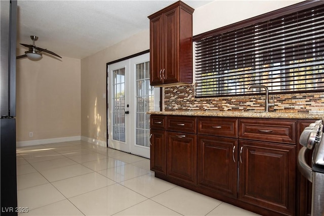 1340 Lucky St, Las Vegas, NV 89104 - kitchen featuring french doors, ceiling fan, light tile patterned floors, and backsplash