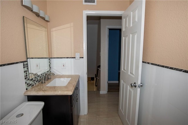 1340 Lucky St, Las Vegas, NV 89104 - bathroom featuring vanity, tile patterned flooring, and a wainscoted wall
