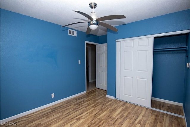1340 Lucky St, Las Vegas, NV 89104 - unfurnished bedroom featuring wood finished floors, a closet, and a ceiling fan