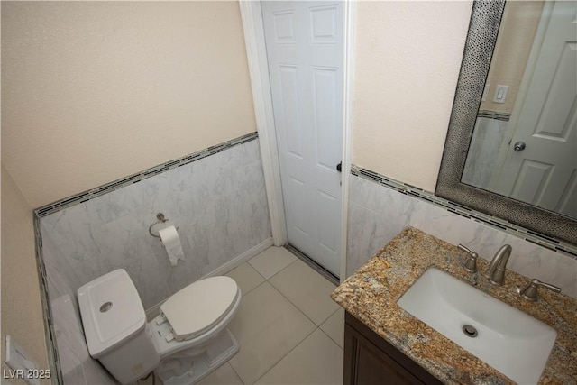1340 Lucky St, Las Vegas, NV 89104 - bathroom with vanity, tile walls, a wainscoted wall, and tile patterned floors
