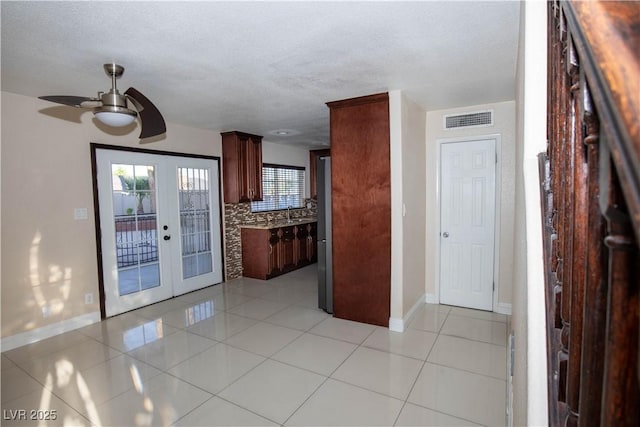 1340 Lucky St, Las Vegas, NV 89104 - kitchen with a ceiling fan, decorative backsplash, french doors, light tile patterned floors, and a textured ceiling