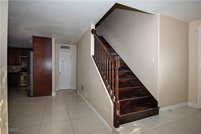 1340 Lucky St, Las Vegas, NV 89104 - stairs with baseboards and tile patterned flooring