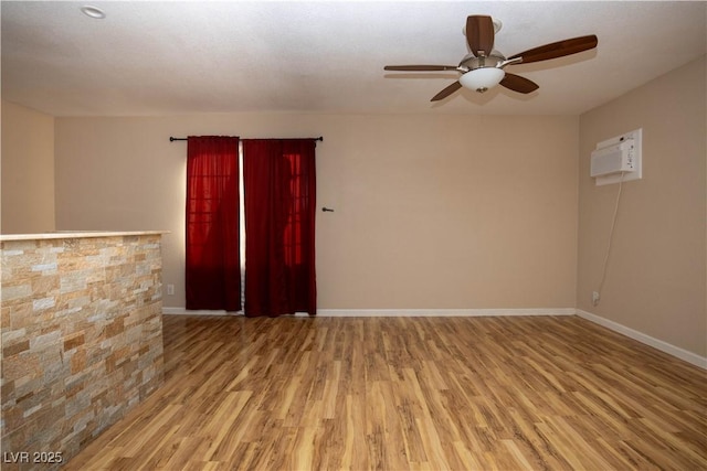1340 Lucky St, Las Vegas, NV 89104 - spare room with wood finished floors, ceiling fan, and a wall mounted air conditioner