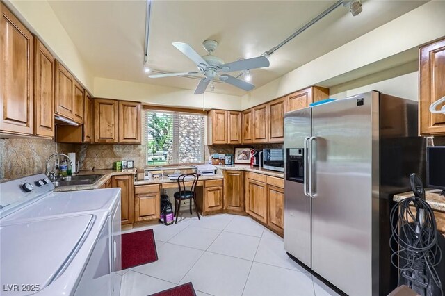2770 La Casita Ave, Las Vegas, NV 89120 - kitchen with appliances with stainless steel finishes, washer and dryer, ceiling fan, brown cabinetry, and light countertops