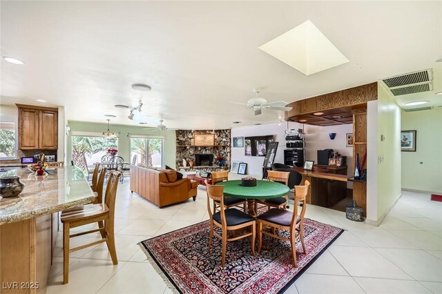 2770 La Casita Ave, Las Vegas, NV 89120 - dining space with a ceiling fan, a fireplace, light tile patterned flooring, and an office area