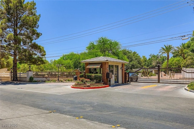 2770 La Casita Ave, Las Vegas, NV 89120 - view of asphalt road with a gate, a gated entry, and curbs