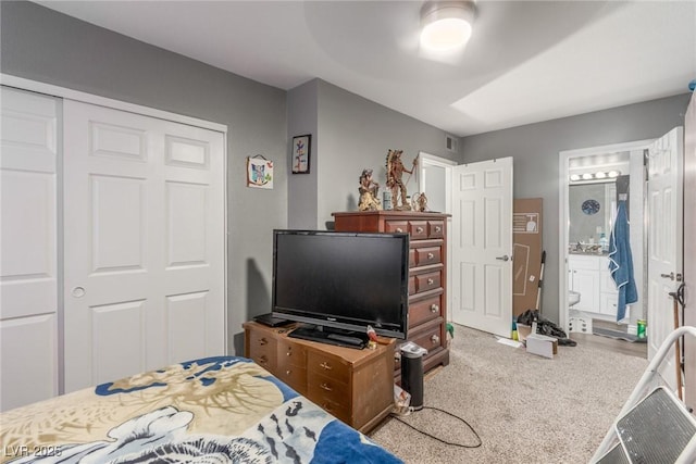 5301 River Glen Dr Unit 205, Las Vegas, NV 89103 - carpeted bedroom with a closet, ceiling fan, and ensuite bath
