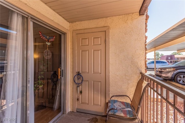 5301 River Glen Dr Unit 205, Las Vegas, NV 89103 - view of exterior entry with stucco siding and a balcony