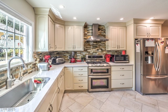 4095 Ridgewood Ave, Las Vegas, NV 89120 - kitchen with appliances with stainless steel finishes, wall chimney range hood, backsplash, light countertops, and recessed lighting