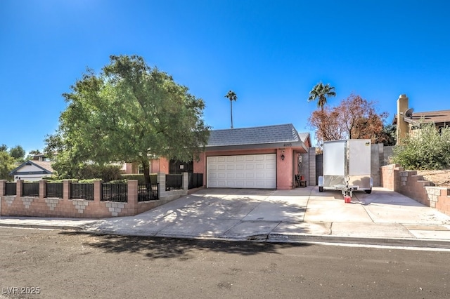 4095 Ridgewood Ave, Las Vegas, NV 89120 - view of front of home with a fenced front yard, an attached garage, stucco siding, and concrete driveway