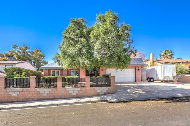 4095 Ridgewood Ave, Las Vegas, NV 89120 - obstructed view of property featuring concrete driveway, a garage, and a fenced front yard