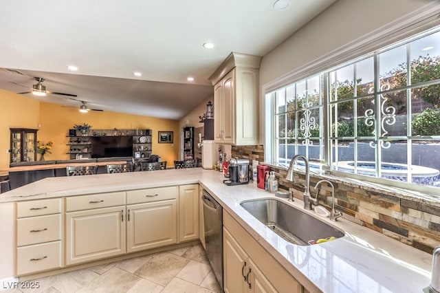 4095 Ridgewood Ave, Las Vegas, NV 89120 - kitchen featuring stainless steel dishwasher, a peninsula, healthy amount of natural light, tasteful backsplash, and lofted ceiling