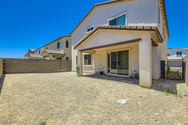 9440 Lunar Ray St, Las Vegas, NV 89143 - back of property with stucco siding, a fenced backyard, and a patio area
