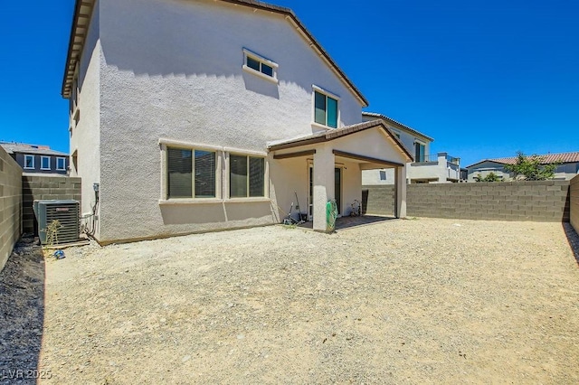 9440 Lunar Ray St, Las Vegas, NV 89143 - rear view of property featuring stucco siding, a fenced backyard, and a patio