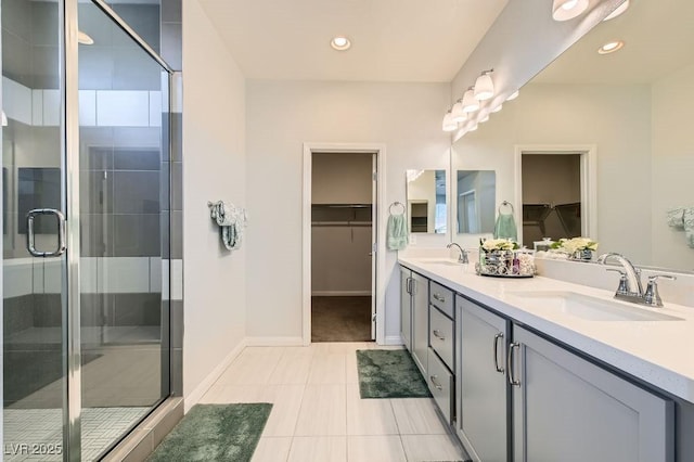 9440 Lunar Ray St, Las Vegas, NV 89143 - bathroom with double vanity, a walk in closet, a shower stall, recessed lighting, and tile patterned flooring