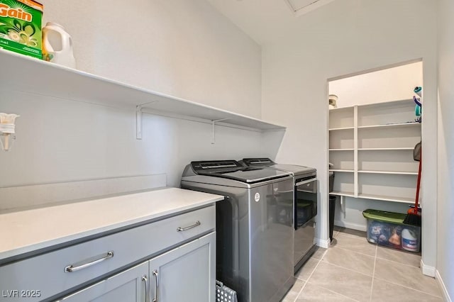 9440 Lunar Ray St, Las Vegas, NV 89143 - washroom featuring independent washer and dryer, light tile patterned flooring, and cabinet space