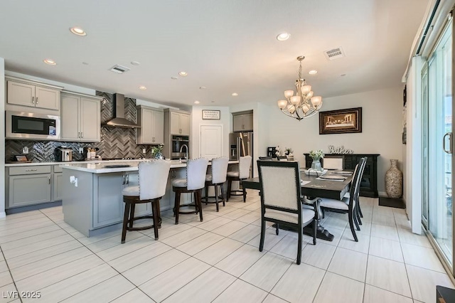 9440 Lunar Ray St, Las Vegas, NV 89143 - dining area with a chandelier, recessed lighting, plenty of natural light, and light tile patterned floors