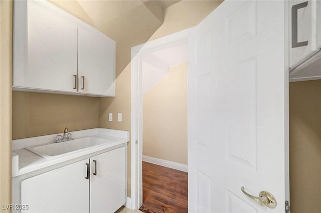 229 N Buteo Woods Ln, Las Vegas, NV 89144 - laundry room with a sink and wood finished floors