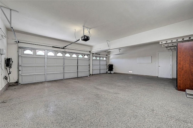 229 N Buteo Woods Ln, Las Vegas, NV 89144 - garage featuring a garage door opener and baseboards