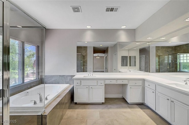 229 N Buteo Woods Ln, Las Vegas, NV 89144 - bathroom featuring double vanity, healthy amount of natural light, a stall shower, a bath, and recessed lighting