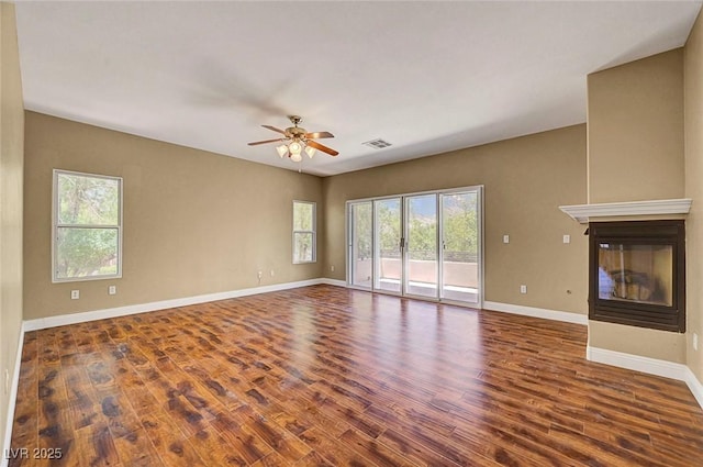 229 N Buteo Woods Ln, Las Vegas, NV 89144 - unfurnished living room featuring ceiling fan, wood finished floors, and a multi sided fireplace