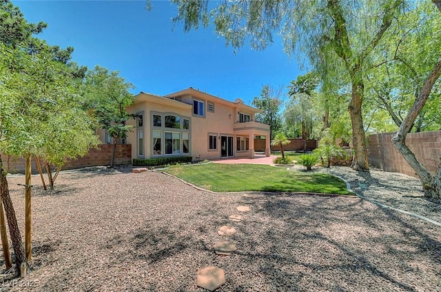 229 N Buteo Woods Ln, Las Vegas, NV 89144 - rear view of house featuring a fenced backyard, stucco siding, and a patio