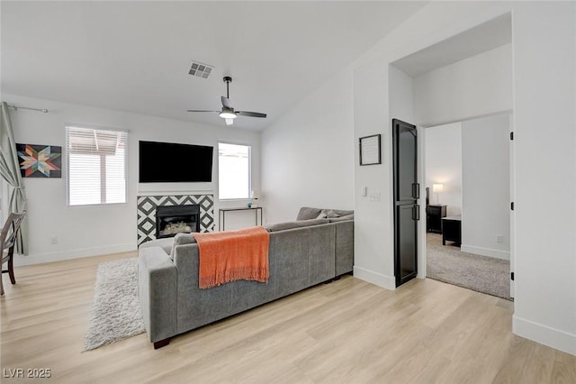 201 Crown Imperial St, Henderson, NV 89074 - living room with light wood finished floors, a ceiling fan, and a fireplace