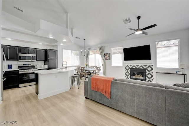201 Crown Imperial St, Henderson, NV 89074 - living room featuring a ceiling fan, light wood finished floors, a fireplace, and recessed lighting