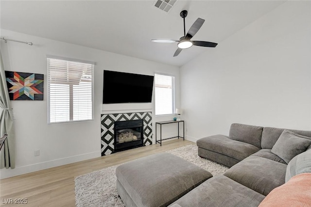 201 Crown Imperial St, Henderson, NV 89074 - living room with light wood-type flooring, ceiling fan, vaulted ceiling, and a fireplace