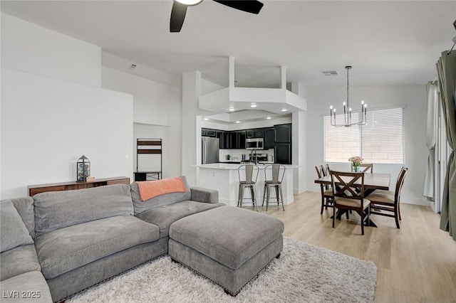 201 Crown Imperial St, Henderson, NV 89074 - living area featuring a chandelier, light wood-style floors, and ceiling fan