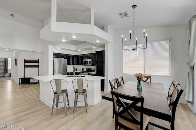201 Crown Imperial St, Henderson, NV 89074 - dining area with light wood finished floors and a chandelier
