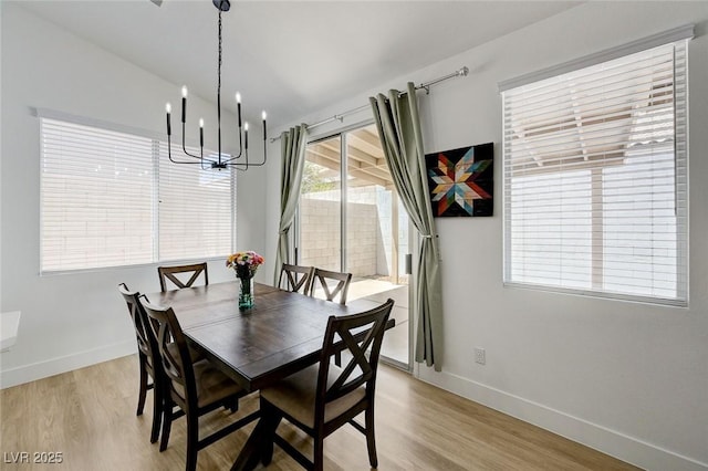 201 Crown Imperial St, Henderson, NV 89074 - dining area featuring a chandelier, light wood-style floors, and vaulted ceiling