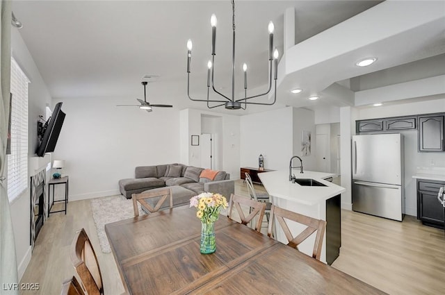 201 Crown Imperial St, Henderson, NV 89074 - dining space featuring a ceiling fan, light wood-type flooring, and a fireplace